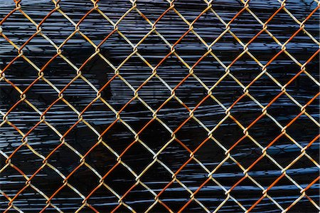 simsearch:6118-09059537,k - Close up of chainlink fence detail, stretched plastic behind. Stock Photo - Premium Royalty-Free, Code: 6118-09059530