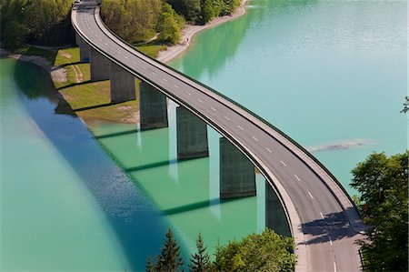 High angle view of tall road bridge crossing dam Stock Photo - Premium Royalty-Free, Code: 6118-09076410