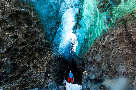 simsearch:6118-09076479,k - Person standing at the entrance to a glacial ice cave. Stock Photo - Premium Royalty-Free, Code: 6118-09076563