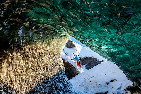 simsearch:6118-09076511,k - View through glacial ice cave with climber in the background. Photographie de stock - Premium Libres de Droits, Code: 6118-09076564