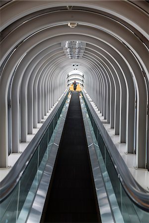 stairs on tunnel - Interior view of contemporary building with escalator running across glass atrium with arched ceiling. Stock Photo - Premium Royalty-Free, Code: 6118-09076592