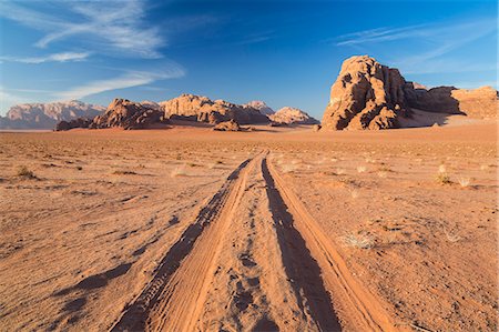 simsearch:6118-08883010,k - Desert landscape with tire tracks leading to distant mountain. Stock Photo - Premium Royalty-Free, Code: 6118-09076597