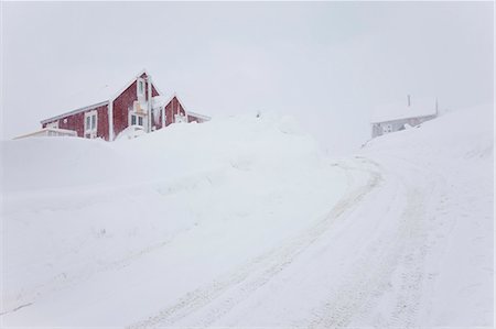 simsearch:6118-07731838,k - Winter landscape with snow-covered road leading to red wooden cottage on a hill. Photographie de stock - Premium Libres de Droits, Code: 6118-09076513