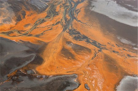 estuario - Aerial view of river estuary or delta, coloured orange by sewerage outlet. Foto de stock - Sin royalties Premium, Código: 6118-09076530
