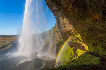 A waterfall cascade over a sheer cliff, a double rainbow in the mist. Foto de stock - Sin royalties Premium, Código: 6118-09076538