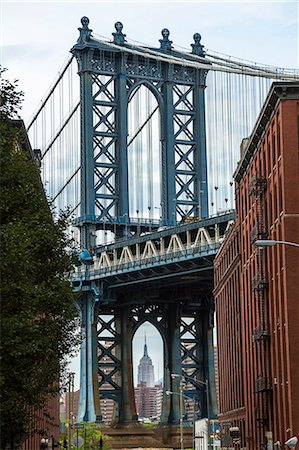 View of Manhattan Bridge from Brooklyn, New York, USA, with Empire State Building in the distance. Stock Photo - Premium Royalty-Free, Code: 6118-09076646