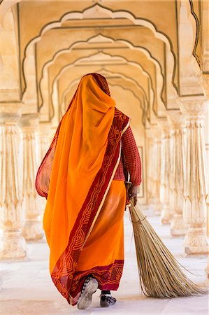 picture of a lady sweeping the floor - Rear view of woman wearing orange sari using broom to sweep floor of a colonnade. Stock Photo - Premium Royalty-Free, Code: 6118-09076677
