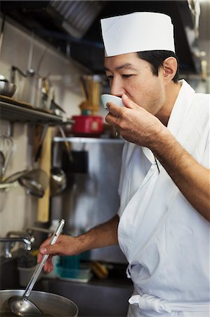 simsearch:6118-09079717,k - Chef working in the kitchen of a Japanese sushi restaurant, tasting food. Stock Photo - Premium Royalty-Free, Code: 6118-09079610