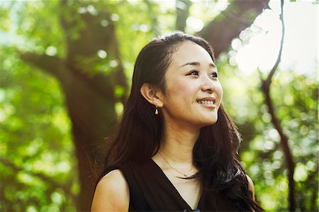 smiling mood - A young woman in woodland, outdoors. Stock Photo - Premium Royalty-Free, Code: 6118-09079635