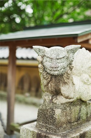 stone base - Close up of Japanese stone sculpture of a guardian animal on stone plinth. Stock Photo - Premium Royalty-Free, Code: 6118-09079813