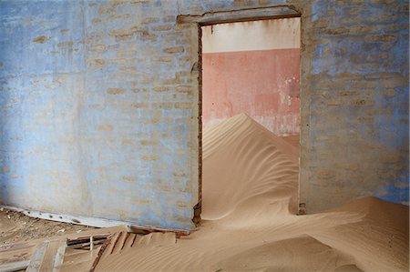 Interior of an abandoned building full of sand. Stock Photo - Premium Royalty-Free, Code: 6118-09018151