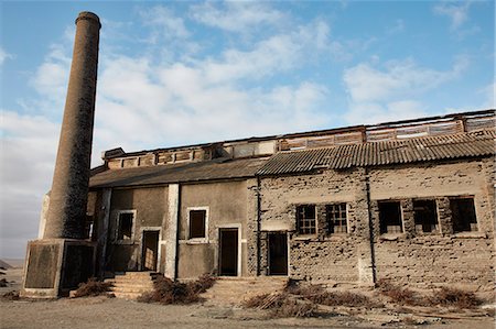 simsearch:841-07081758,k - Exterior view of an abandoned building and industrial chimney. Photographie de stock - Premium Libres de Droits, Code: 6118-09018152