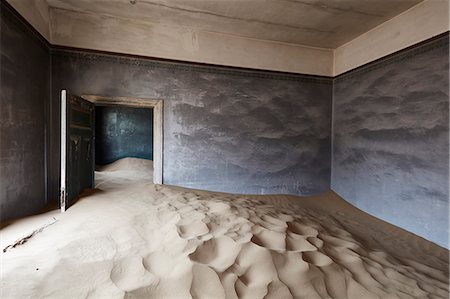 Interior of an abandoned building full of sand. Stock Photo - Premium Royalty-Free, Code: 6118-09018157