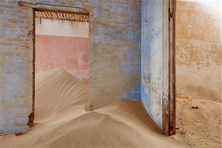 Interior of an abandoned building full of sand. Stock Photo - Premium Royalty-Free, Code: 6118-09018158