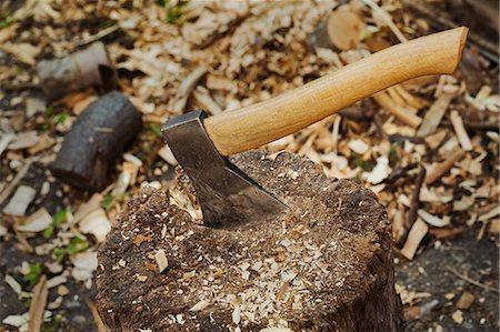 The metal blade of an axe with a smooth wooden handle stuck in splitting block covered in wood shavings. Foto de stock - Sin royalties Premium, Código: 6118-09018580