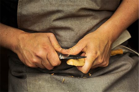 stanley knife - Close up of a craftsman's hands pressing and shaping a small piece of wood into a spoon with a sharp knife blade, shaping the bowl back. Stock Photo - Premium Royalty-Free, Code: 6118-09018587