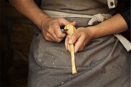 stanley knife - Close up of a craftsman shaping a small piece of wood with a sharp carving knife. Stock Photo - Premium Royalty-Free, Code: 6118-09018589