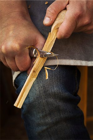 stanley knife - Close up of a craftsman shaping a small piece of wood with a sharp carving knife. Stock Photo - Premium Royalty-Free, Code: 6118-09018590