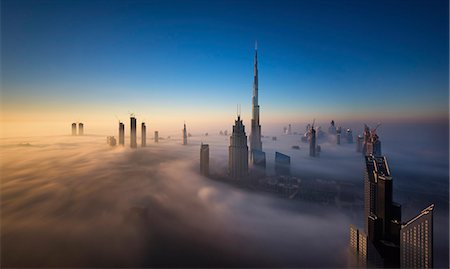 View of the Burj Khalifa and other skyscrapers above the clouds in Dubai, United Arab Emirates. Stock Photo - Premium Royalty-Free, Code: 6118-09028157