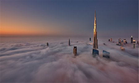 simsearch:6118-09028165,k - View of the Burj Khalifa and other skyscrapers above the clouds in Dubai, United Arab Emirates. Stock Photo - Premium Royalty-Free, Code: 6118-09028156