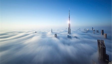 simsearch:649-08565619,k - View of the Burj Khalifa and other skyscrapers above the clouds in Dubai, United Arab Emirates. Foto de stock - Sin royalties Premium, Código: 6118-09028167