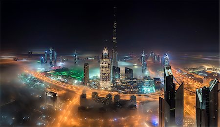 simsearch:841-03034485,k - Cityscape of Dubai, United Arab Emirates with illuminated Burj Khalifa and other skyscrapers. Stock Photo - Premium Royalty-Free, Code: 6118-09028166