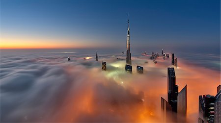 simsearch:649-08565623,k - View of the Burj Khalifa and other skyscrapers above the clouds in Dubai, United Arab Emirates. Foto de stock - Sin royalties Premium, Código: 6118-09028170