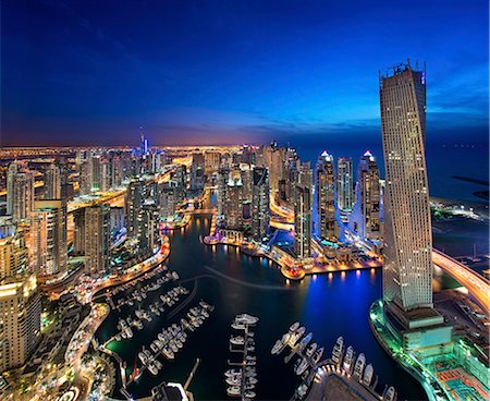 simsearch:841-03034485,k - Aerial view of the cityscape of Dubai, United Arab Emirates at dusk, with illuminated skyscrapers and the marina in the foreground. Stock Photo - Premium Royalty-Free, Code: 6118-09028183