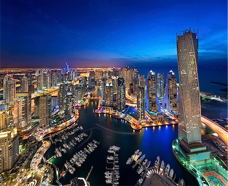 simsearch:6118-09028246,k - Aerial view of the cityscape of Dubai, United Arab Emirates at dusk, with illuminated skyscrapers and the marina in the foreground. Stock Photo - Premium Royalty-Free, Code: 6118-09028183