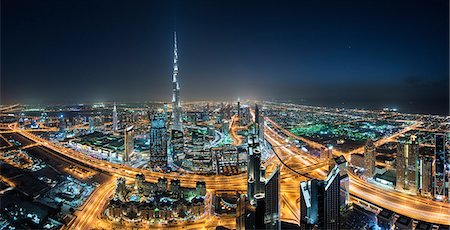 simsearch:6118-09028246,k - Cityscape of Dubai, United Arab Emirates at night, with the Burj Khalifa skyscraper in the distance. Stock Photo - Premium Royalty-Free, Code: 6118-09028181