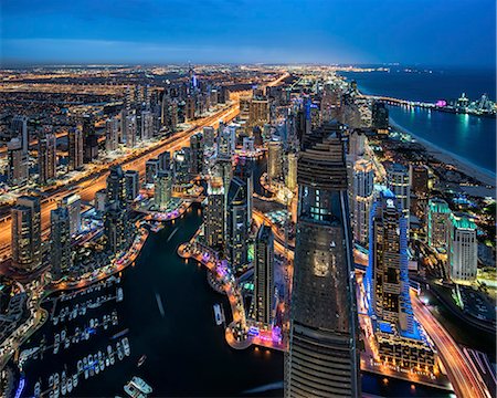 simsearch:862-07690918,k - Aerial view of the cityscape of Dubai, United Arab Emirates at dusk, with illuminated skyscrapers and the marina in the foreground. Stock Photo - Premium Royalty-Free, Code: 6118-09028184