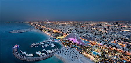 simsearch:6118-09028240,k - Cityscape of Dubai, United Arab Emirates at dusk, with coastline of Persian Gulf and marina in the foreground. Stock Photo - Premium Royalty-Free, Code: 6118-09028186