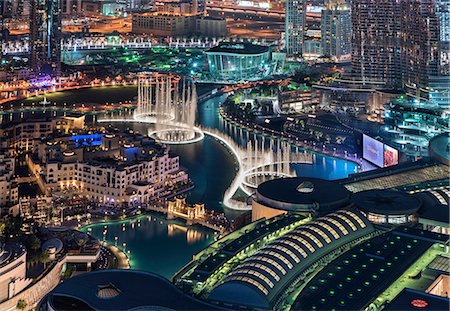 simsearch:6118-09028240,k - Cityscape of Dubai, United Arab Emirates at dusk, with illuminated skyscrapers and the marina in the foreground. Stock Photo - Premium Royalty-Free, Code: 6118-09028195