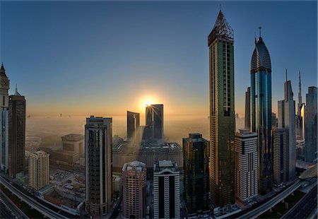 simsearch:6118-09028165,k - Cityscape with illuminated skyscrapers in Dubai, United Arab Emirates at dusk. Stock Photo - Premium Royalty-Free, Code: 6118-09028196