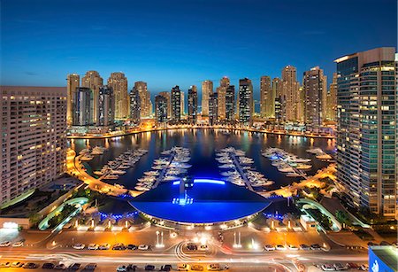 simsearch:6118-09028243,k - Cityscape of Dubai, United Arab Emirates at dusk, with illuminated skyscrapers and the marina in the foreground. Stock Photo - Premium Royalty-Free, Code: 6118-09028199