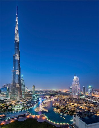 simsearch:841-03034485,k - Cityscape of Dubai, United Arab Emirates at dusk, with illuminated Burj Khalifa skyscraper in the foreground. Stock Photo - Premium Royalty-Free, Code: 6118-09028253