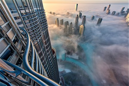 simsearch:6118-09028245,k - Aerial view of cityscape with skyscrapers above the clouds in Dubai, United Arab Emirates. Photographie de stock - Premium Libres de Droits, Code: 6118-09028206