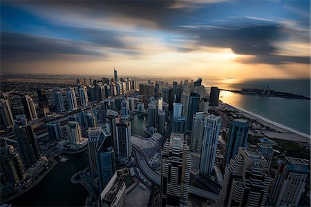 simsearch:6118-09028243,k - Cityscape of the Dubai, United Arab Emirates at dusk, with skyscrapers and coastline of the Persian Gulf. Stock Photo - Premium Royalty-Free, Code: 6118-09028221