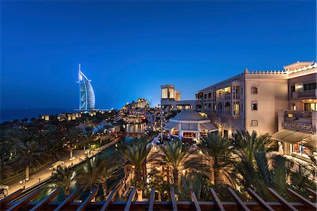 simsearch:6118-09028246,k - Cityscape of the Dubai, United Arab Emirates at dusk, with illuminated buildings and the Burj Al Arab in the distance. Stock Photo - Premium Royalty-Free, Code: 6118-09028222