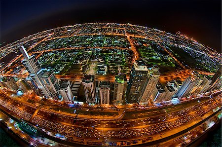 simsearch:6102-08120527,k - Aerial fish-eye view of  Dubai, United Arab Emirates at night. Photographie de stock - Premium Libres de Droits, Code: 6118-09028226