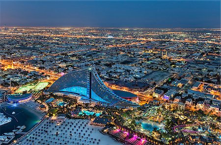 simsearch:841-03034485,k - Aerial view of the cityscape of Dubai, United Arab Emirates at dusk, with the Jumeirah Beach Hotel and the marina in the foreground. Stock Photo - Premium Royalty-Free, Code: 6118-09028233