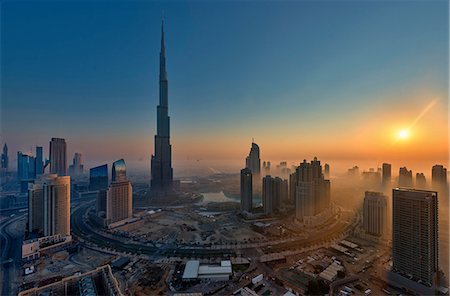 simsearch:841-03034485,k - Cityscape of Dubai, United Arab Emirates at dusk, with the Burj Khalifa skyscraper and other buildings in the foreground. Stock Photo - Premium Royalty-Free, Code: 6118-09028231