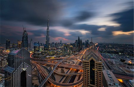 road to success - Cityscape of the Dubai, United Arab Emirates, with the Burj Khalifa and other skyscrapers under a cloudy sky. Stock Photo - Premium Royalty-Free, Code: 6118-09028239