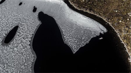 people on cliff - Aerial view of ice floe in Lofoten Islands, Norway. Stock Photo - Premium Royalty-Free, Code: 6118-09039325