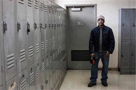 Black man factory worker standing next to lockers in a factory break room. Stock Photo - Premium Royalty-Free, Code: 6118-09140045