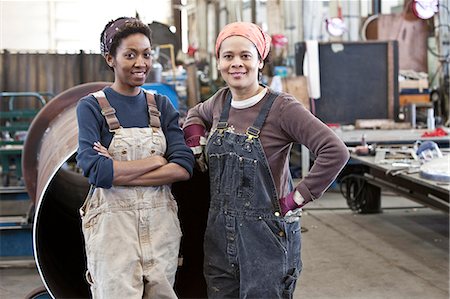 simsearch:6118-09139994,k - Black women team of factory workers in a sheet metal factory. Foto de stock - Sin royalties Premium, Código: 6118-09140074