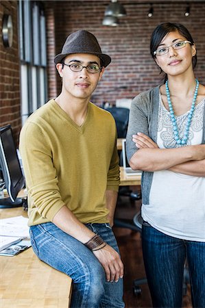 simsearch:6118-08729048,k - Asian woman and Hispanic man together at a creative office work station. Photographie de stock - Premium Libres de Droits, Code: 6118-09140027