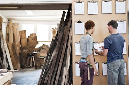 simsearch:6118-09148255,k - Woman and man team of factory workers checking project inventory in a woodworking factory. Foto de stock - Sin royalties Premium, Código: 6118-09140137