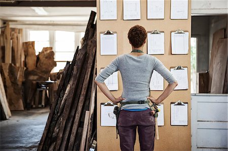 factory workers in usa - Woman factory worker checking project inventory in a woodworking factory. Stock Photo - Premium Royalty-Free, Code: 6118-09140136