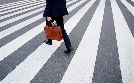 simsearch:6118-09144990,k - High angle view of person carrying brown briefcase walking across pedestrian crossing. Stock Photo - Premium Royalty-Free, Code: 6118-09144846